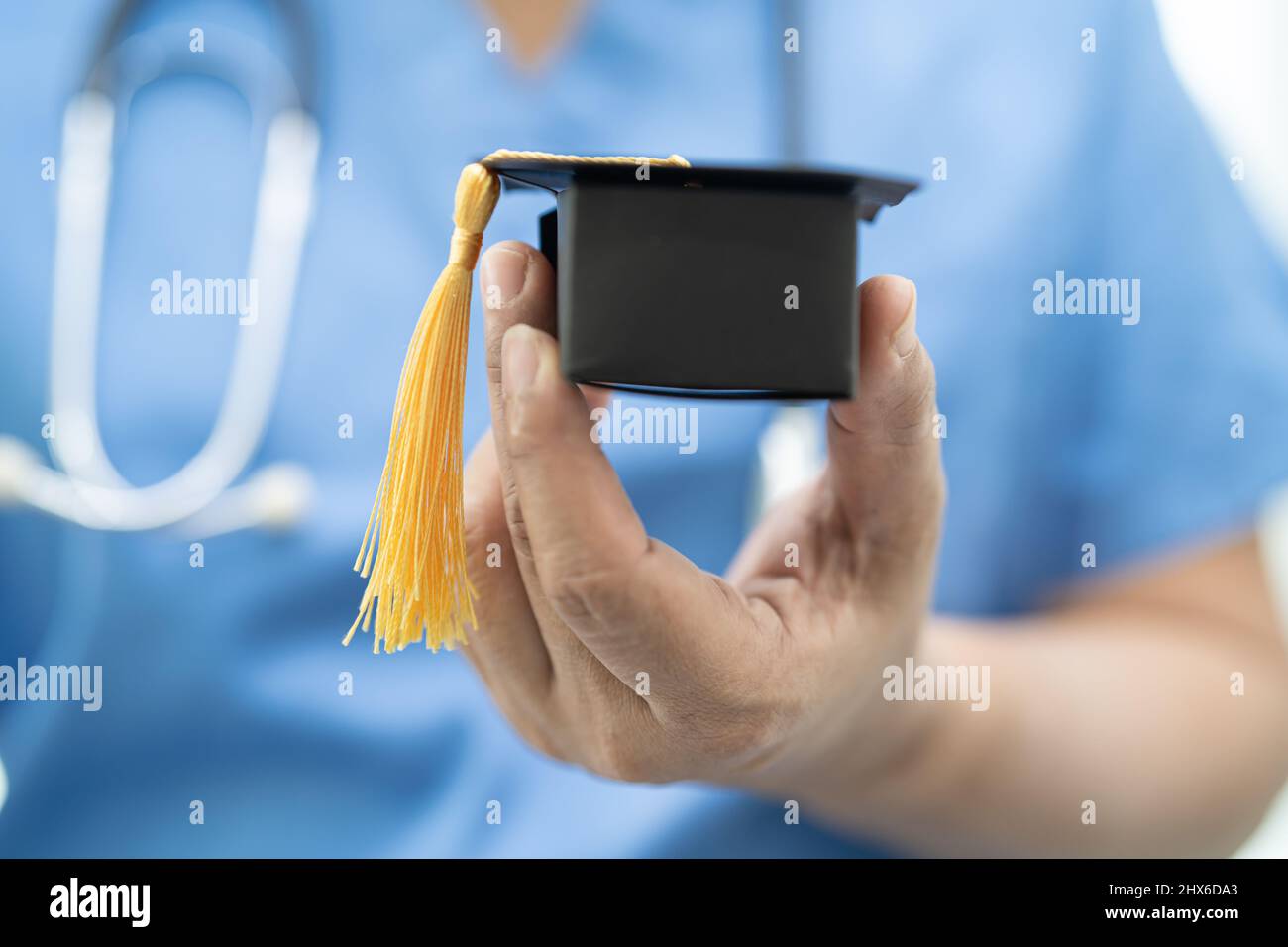 Doctoe Graduation Asian doctor study learn with graduation gap hat in hospital ward ...