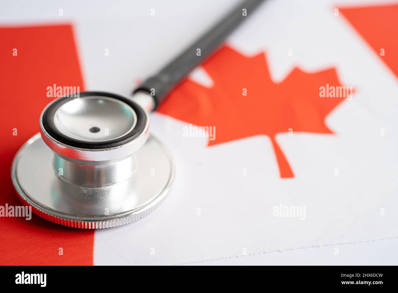 Black stethoscope on Canada flag background, Business and finance