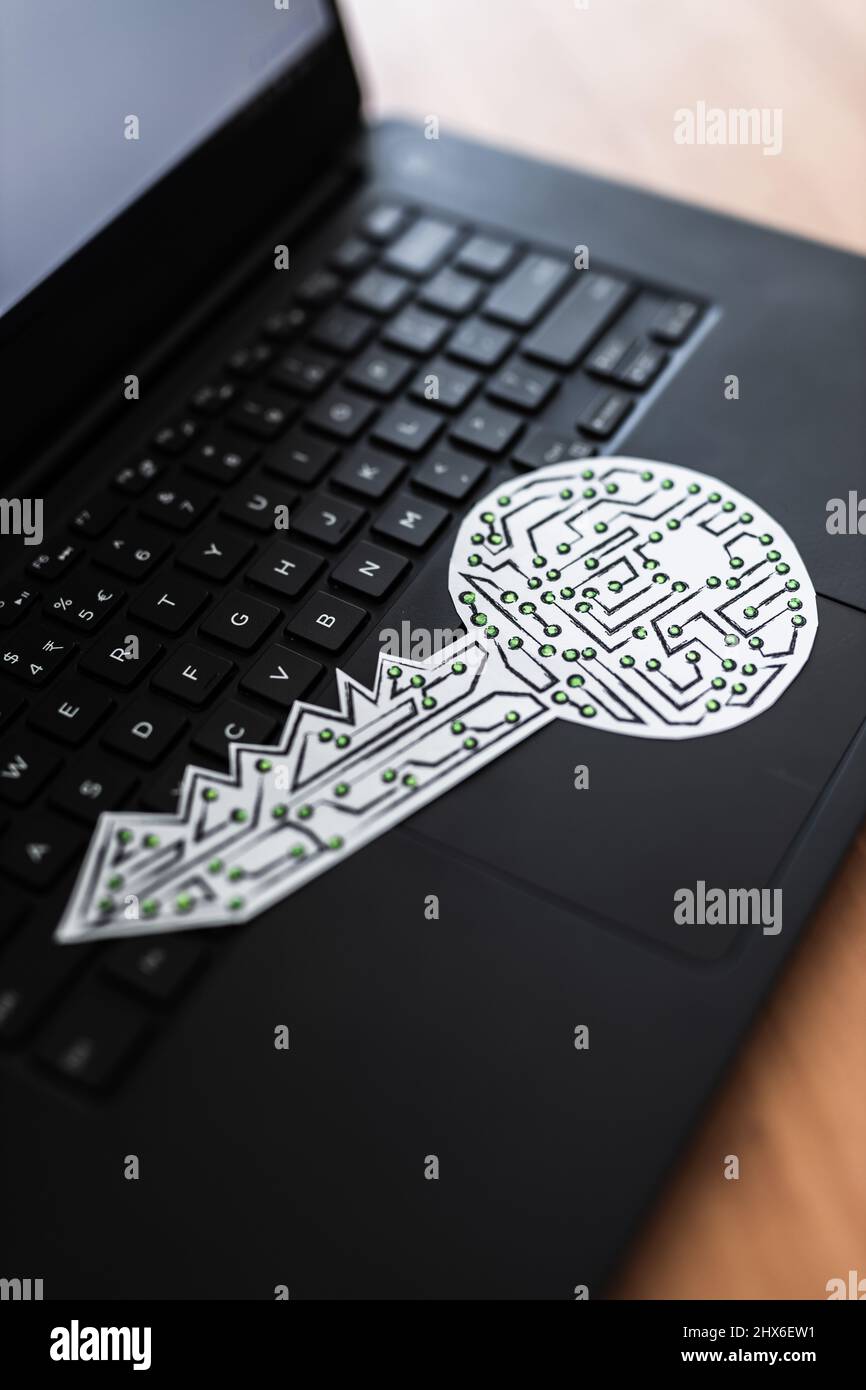 encryption key icon made of circuits and LED lights on top of laptop ...