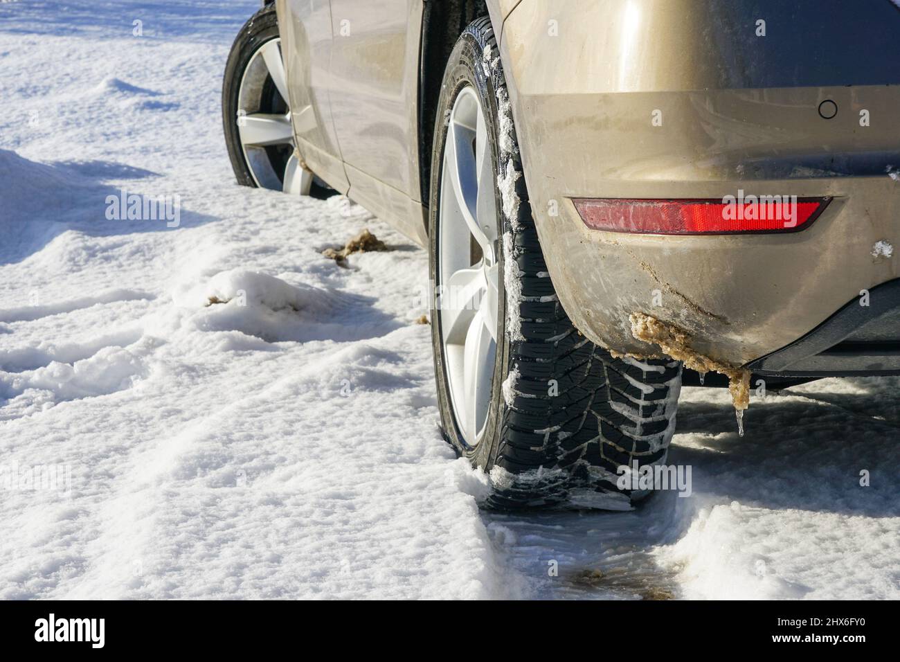 Detail of car tires on winter road covered with snow Stock Photo - Alamy