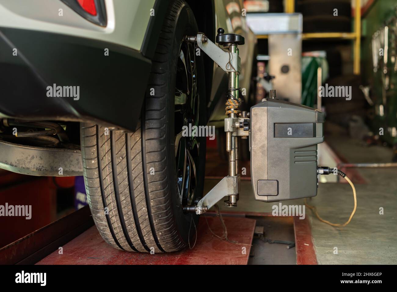 car wheel alignment in progress at auto repair service station Stock