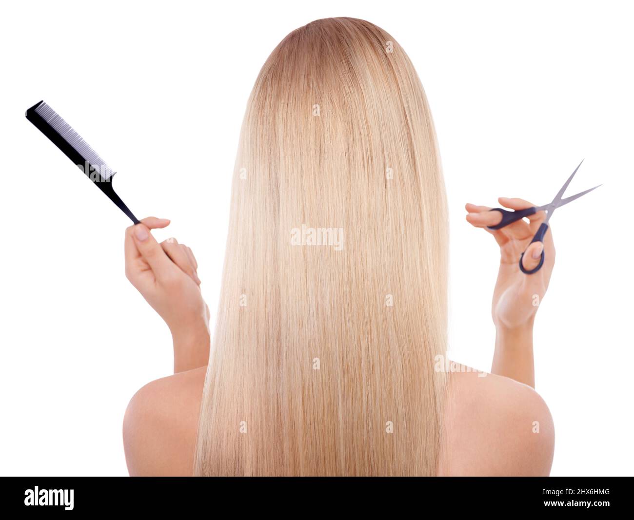 Ready for a haircut. Rearview shot of a blonde woman holding scissors and a comb. Stock Photo