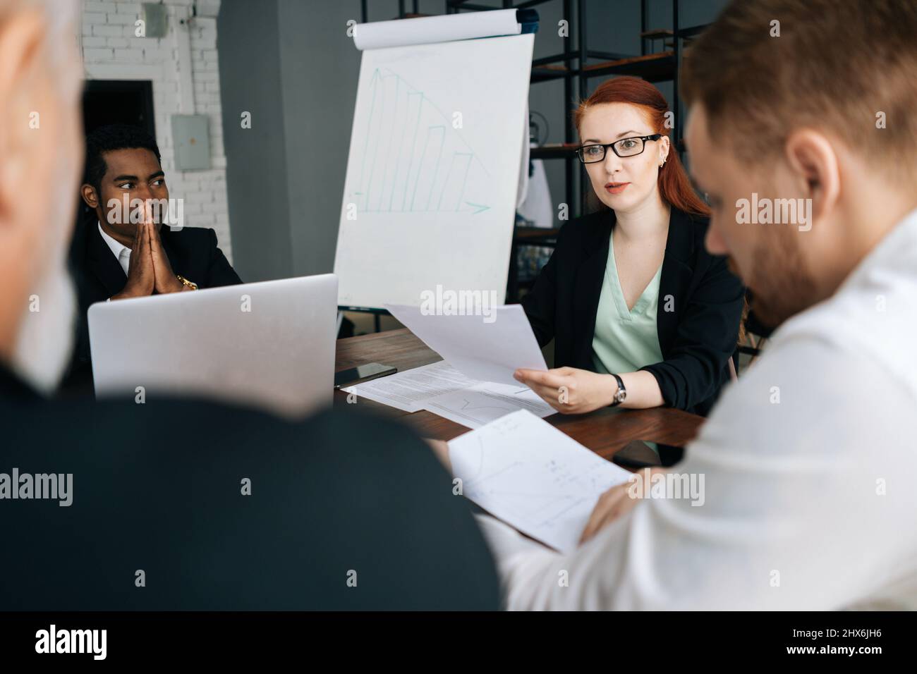Group of successful diverse business people listening female leader ...