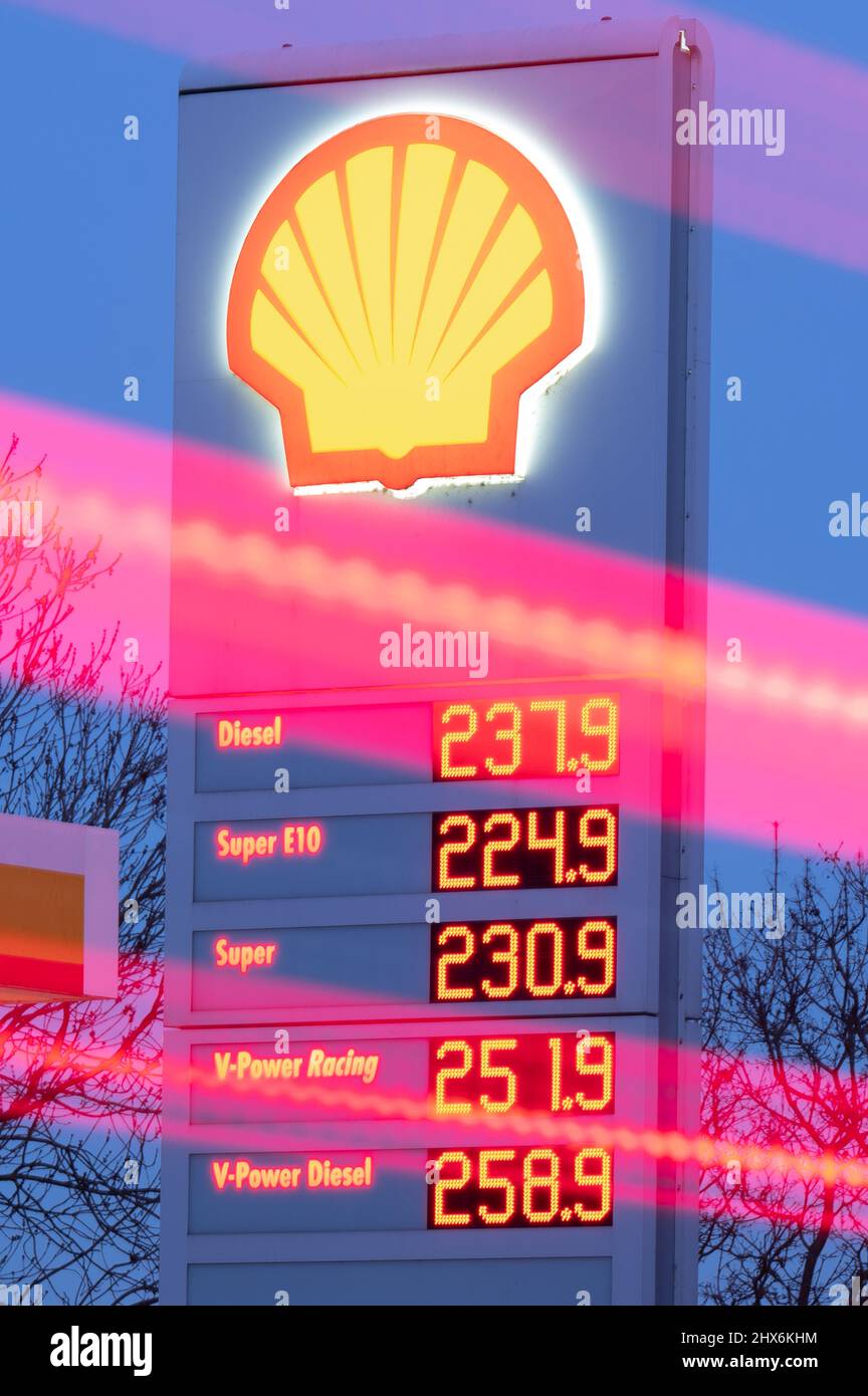 Dresden, Germany. 10th Mar, 2022. The headlights of passing vehicles trace light trails on a street while the price board from a gas station displays gasoline prices in the background. The war in Ukraine has caused fuel prices to rise above the two-euro threshold for the first time. Credit: Sebastian Kahnert/dpa-Zentralbild/dpa/Alamy Live News Stock Photo