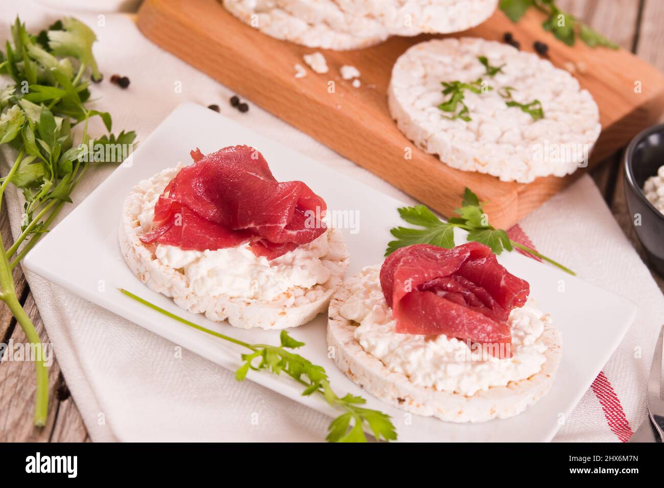 Rice cakes with milk flakes and cold beef Stock Photo - Alamy