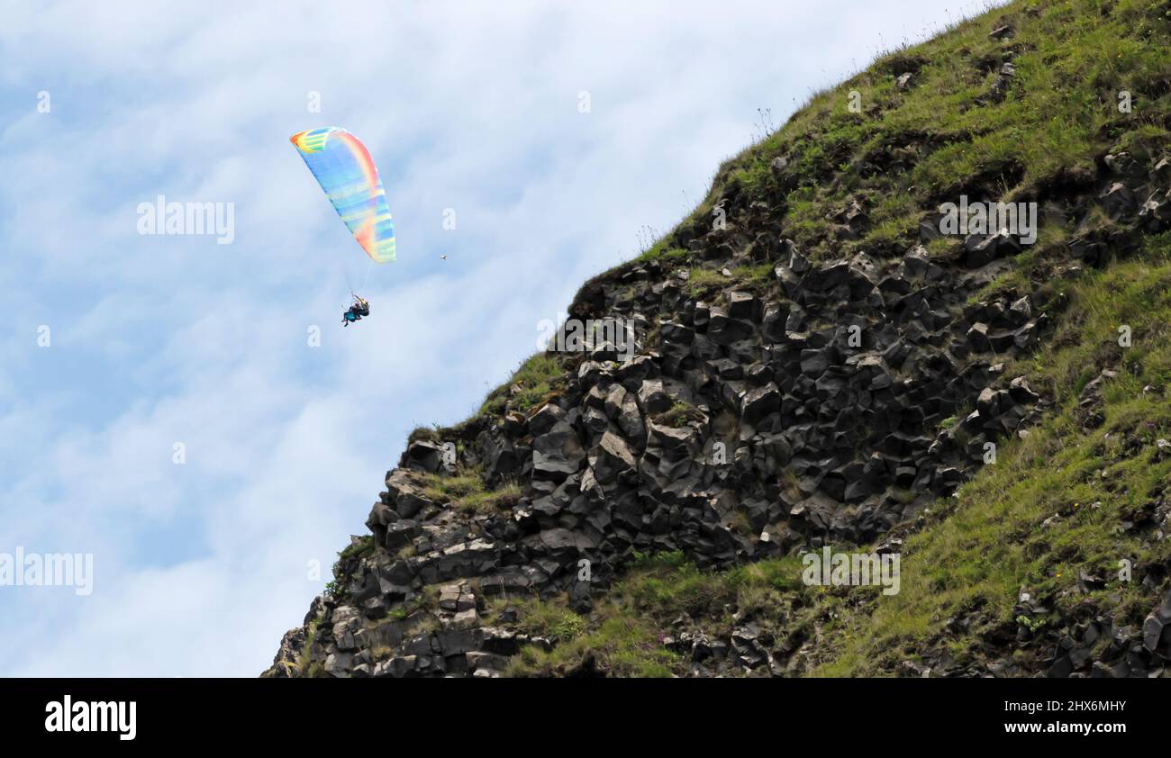 Vik, Iceland on july 30, 2021: Tandem paragliders flying through the air near Vik Stock Photo