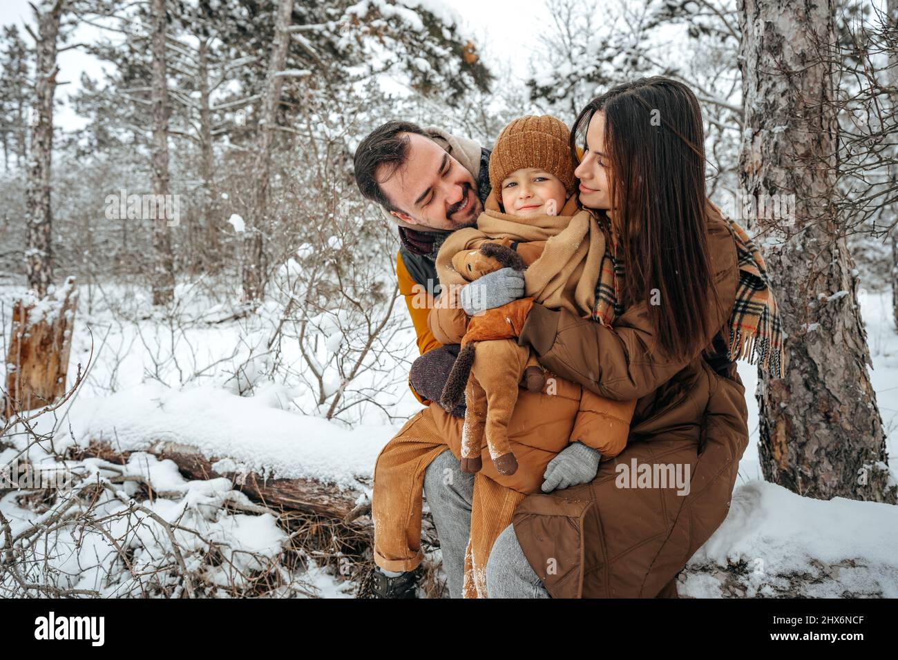 Portrait of happy family in winter clothes in forest Stock Photo - Alamy