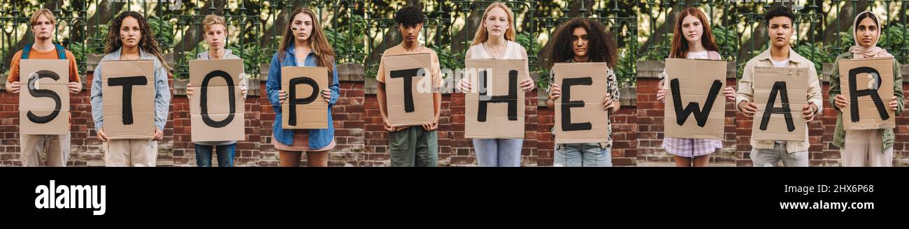 Collage showing group of young people protesting against the war in Ukraine. Diverse young adults looking at the camera while holding posters that rea Stock Photo