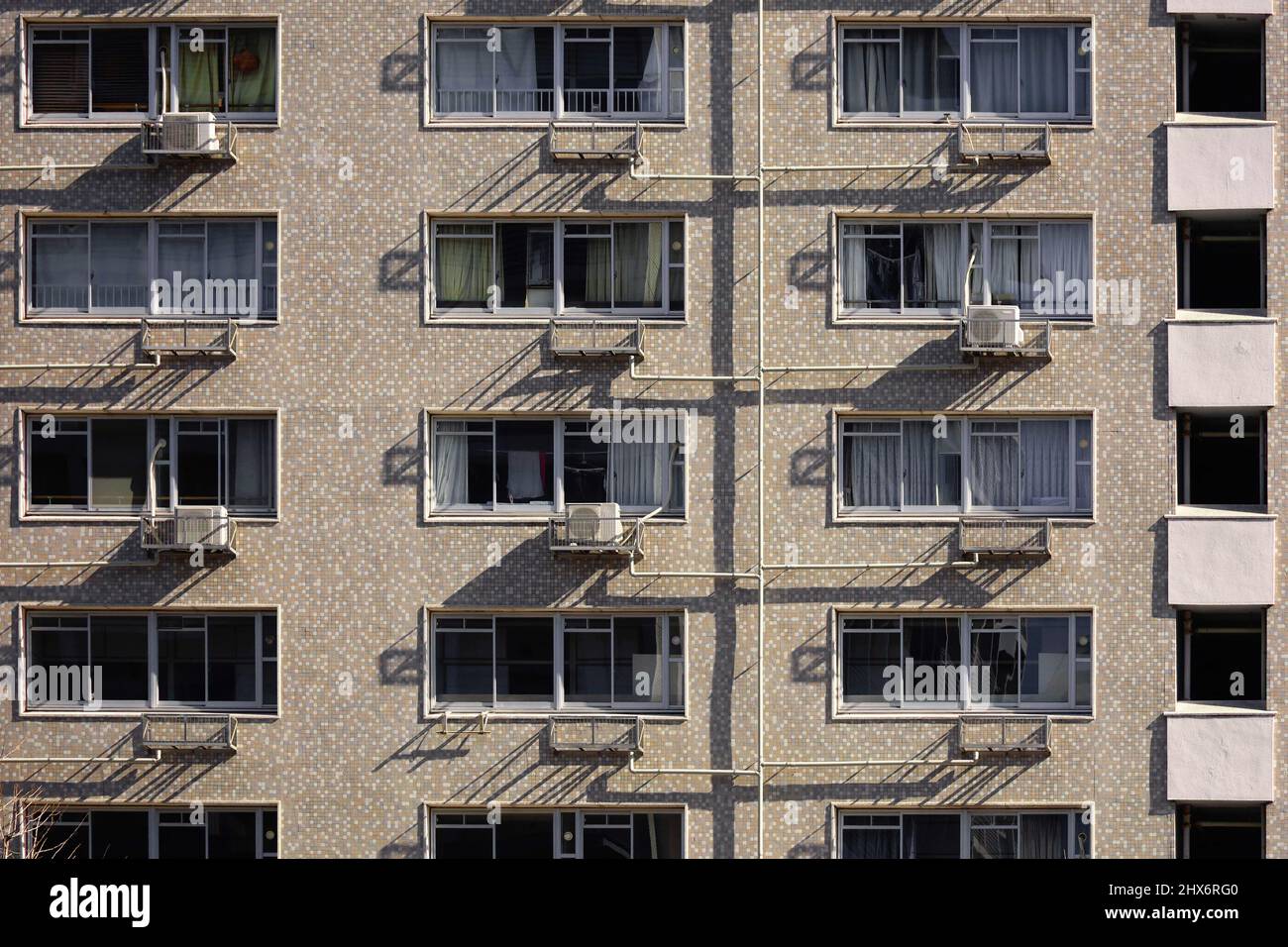 Close up photo of the exterior of a Japanese apartment building built in the 1970s Stock Photo