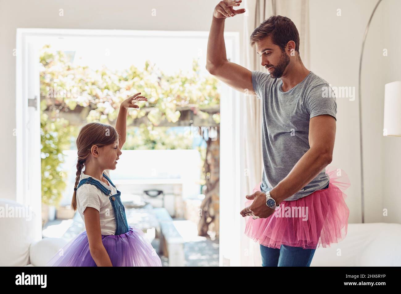 Who says dads cant dance. Shot of a father and daughter dancing in their tutus. Stock Photo