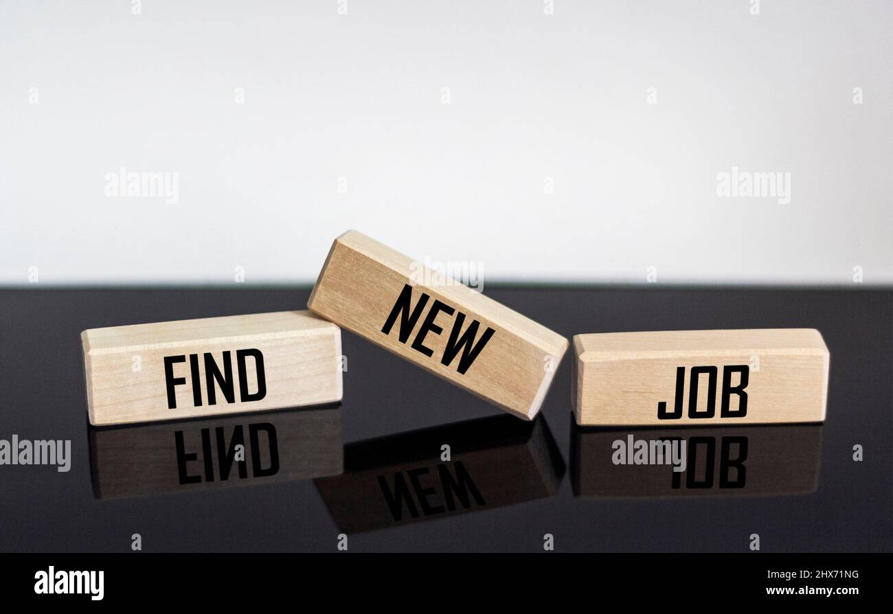 FIND NEW JOB text on wooden blocks and black and white background Stock Photo