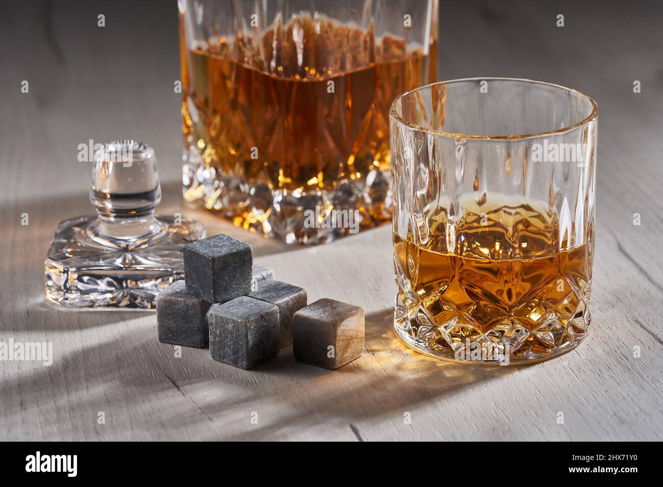 Whiskey on the rocks on a wooden board Stock Photo - Alamy
