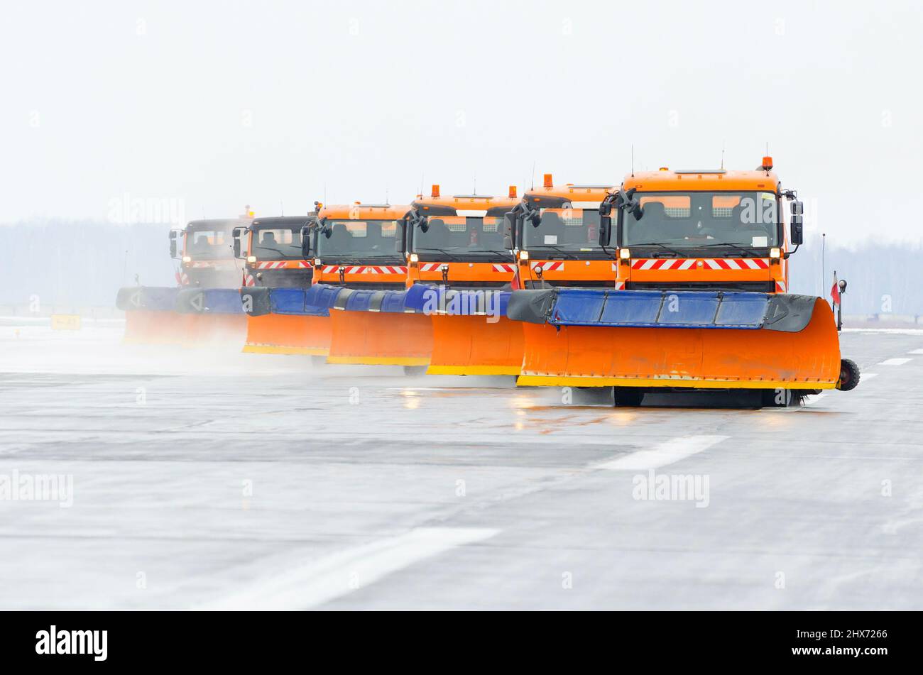Snowplows in the work on the runway at the airport Stock Photo - Alamy