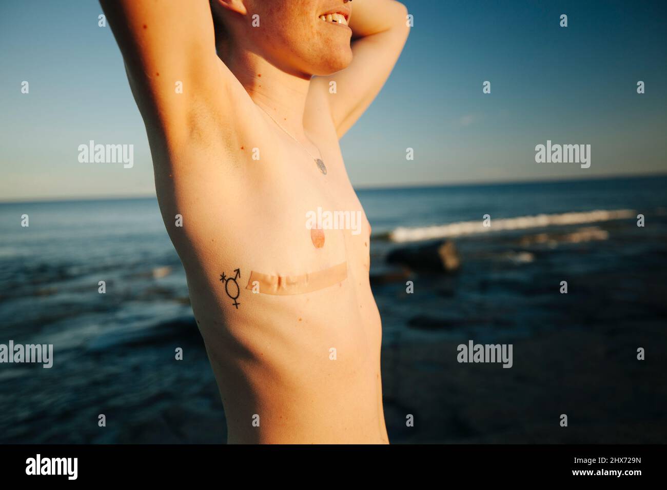 Man with transgender tattoo on naked chest Stock Photo - Alamy