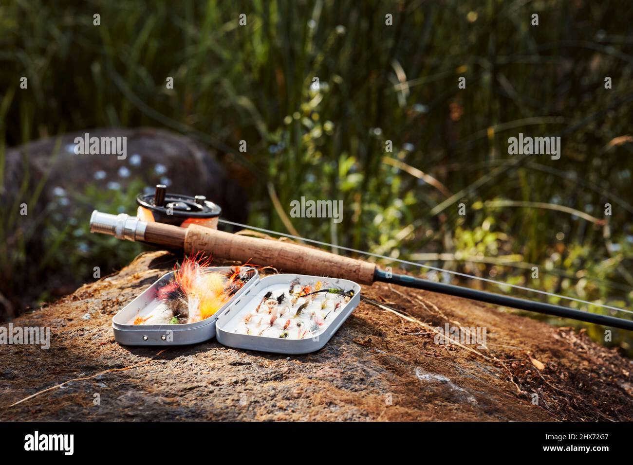 Fishing flies and fishing rod Stock Photo