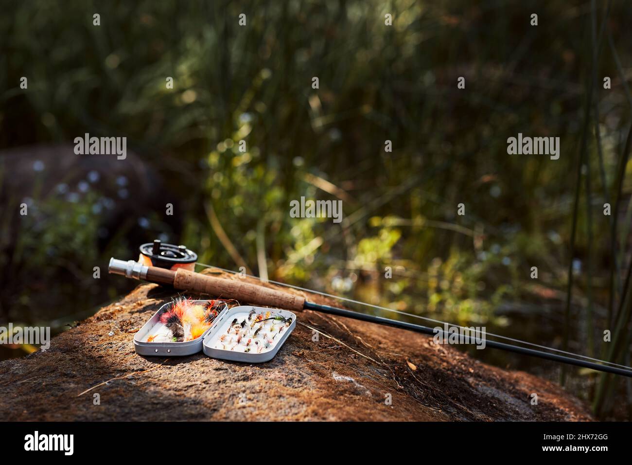 Fishing flies and fishing rod Stock Photo