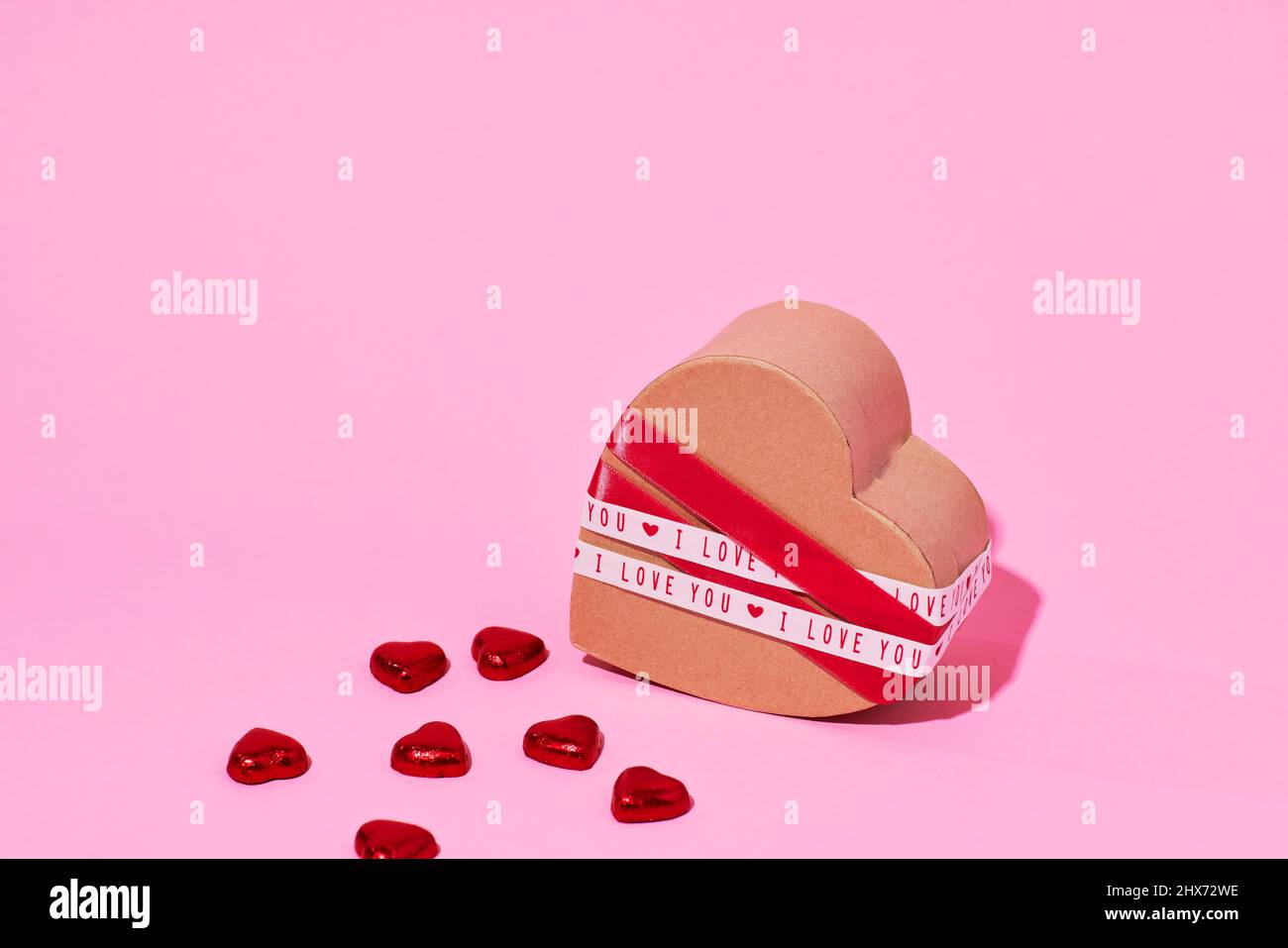Candies and heart-shaped box Stock Photo
