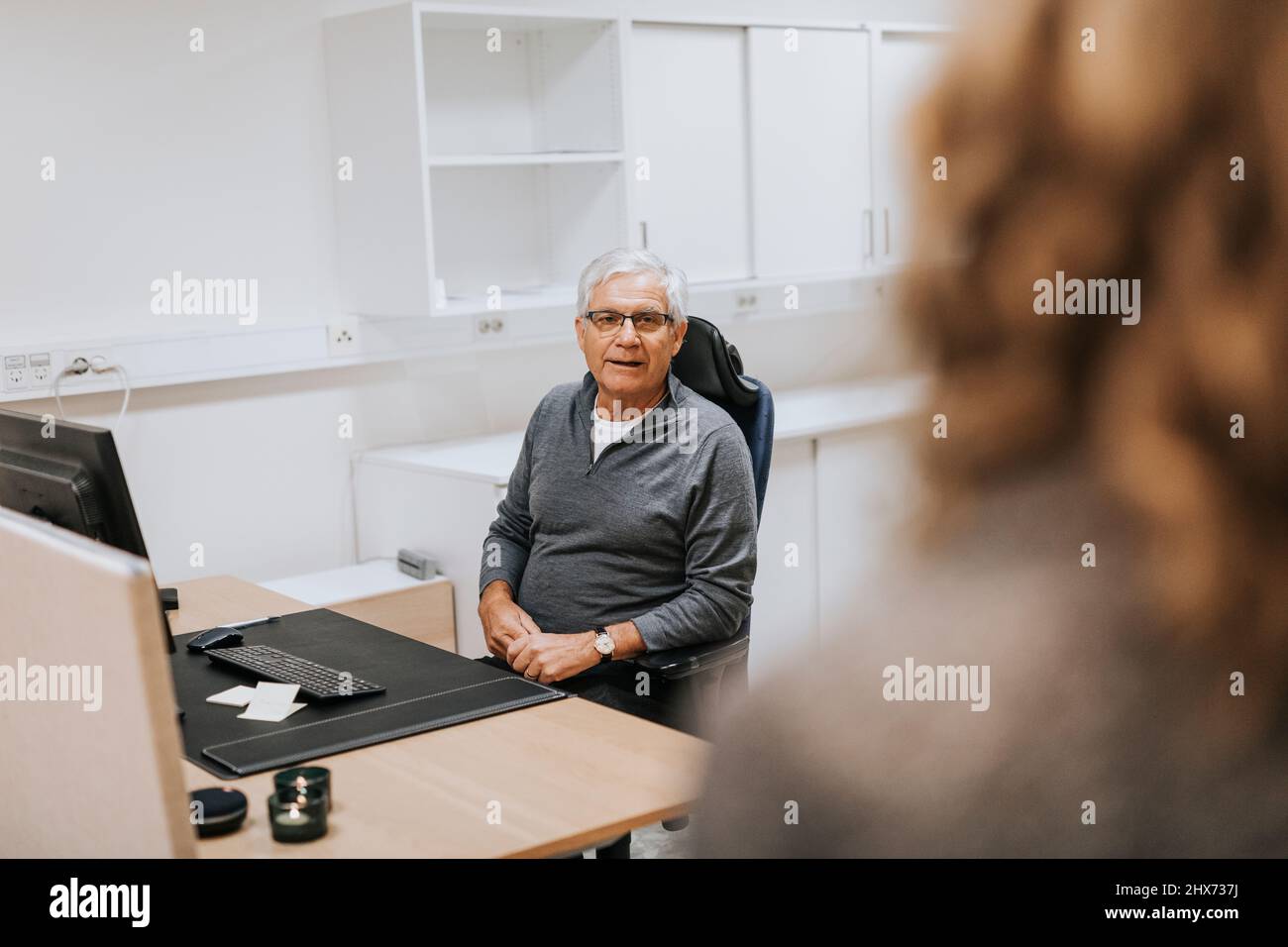 Senior man sitting in office Stock Photo