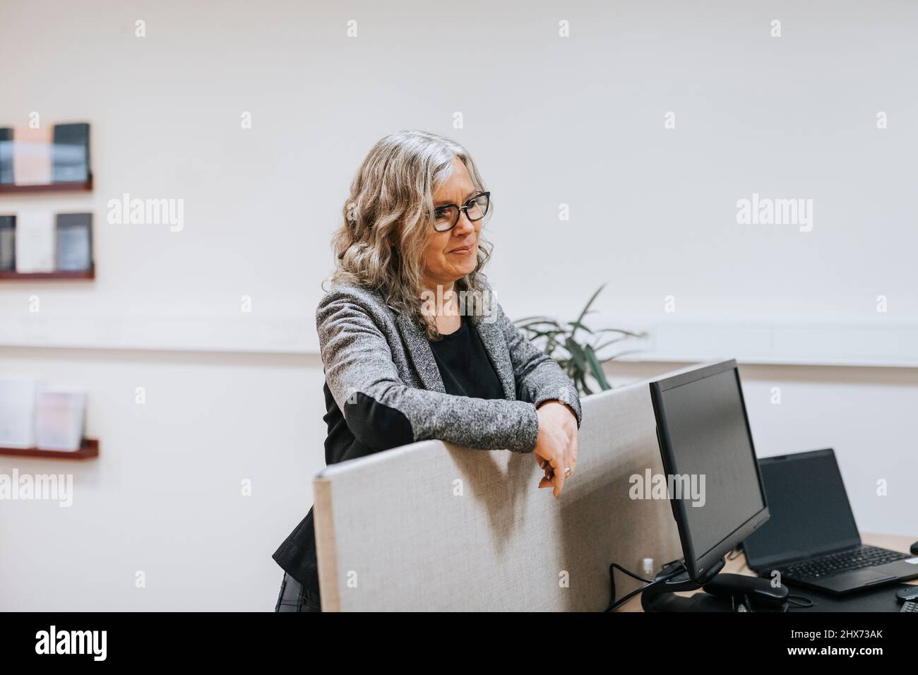 Woman standing work office hi-res stock photography and images - Alamy