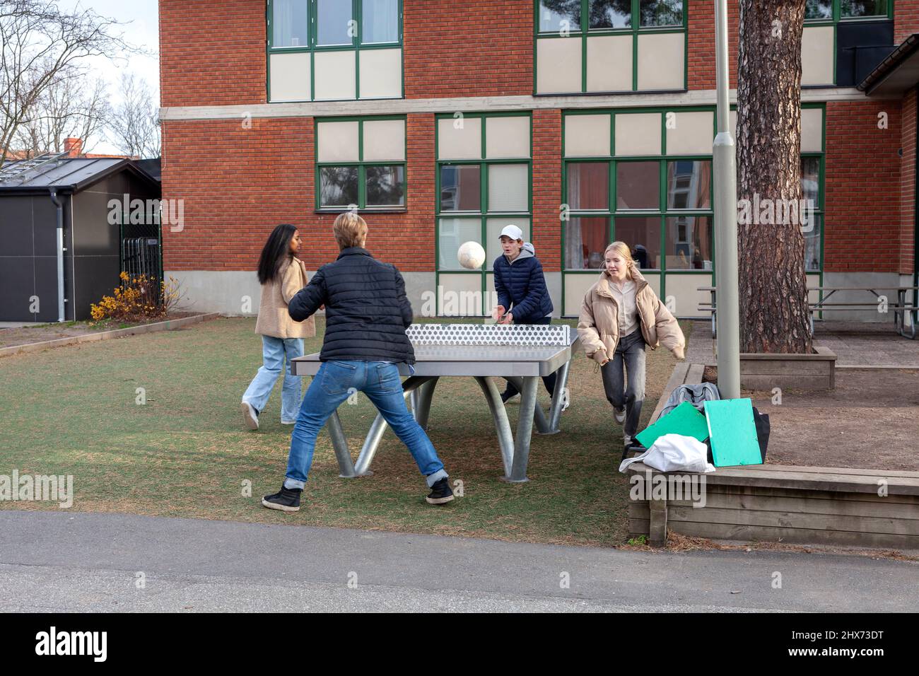 Group of teenagers playing table ball game Stock Photo Alamy