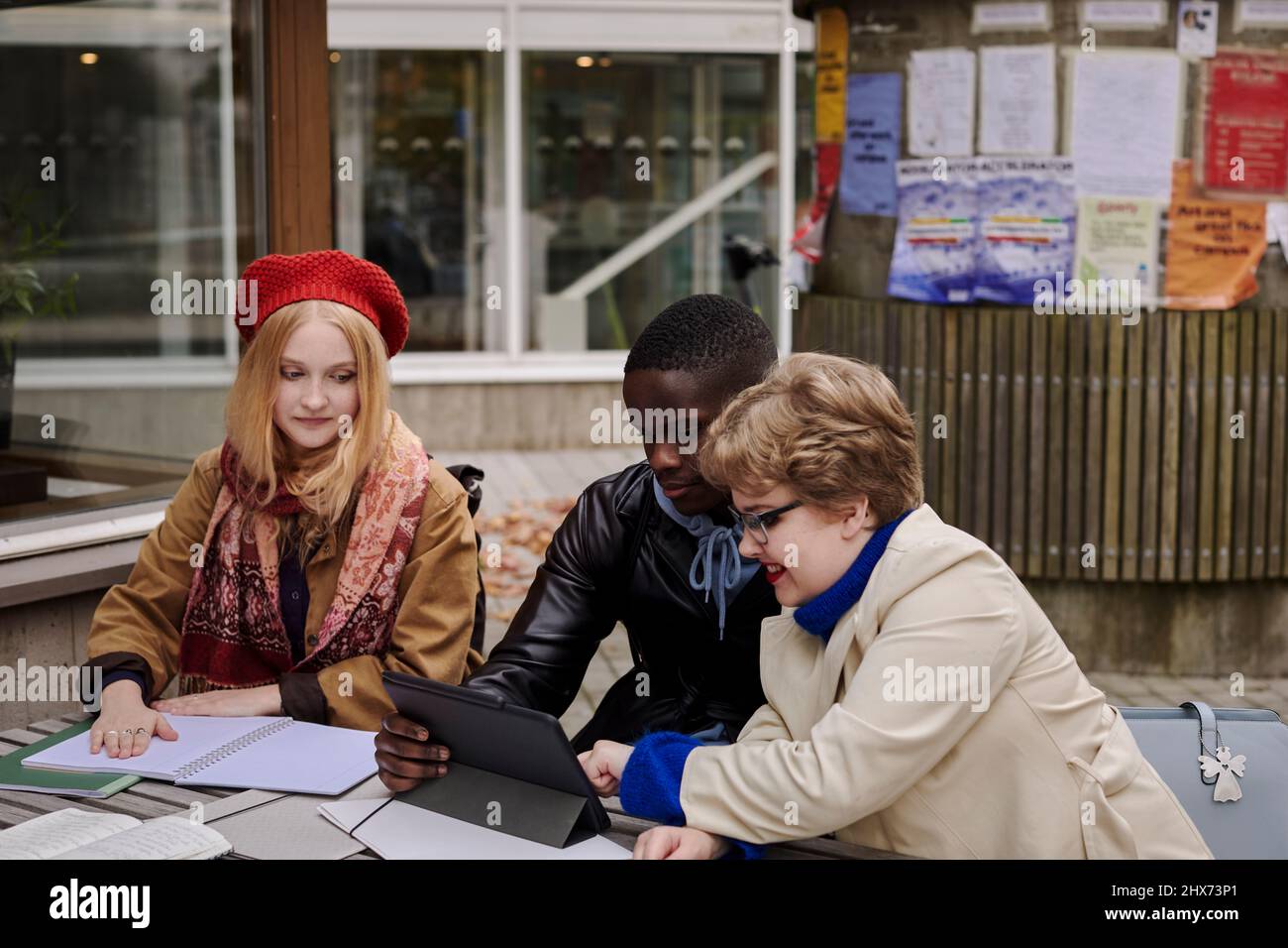 Young friends sitting together Stock Photo