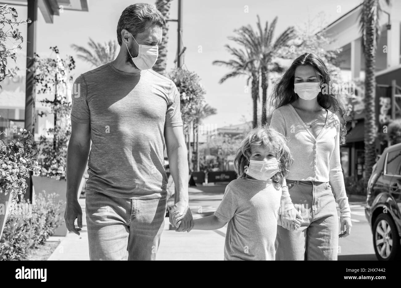 young family of mother father and son boy wear protective mask walking outdoor, family healthcare Stock Photo