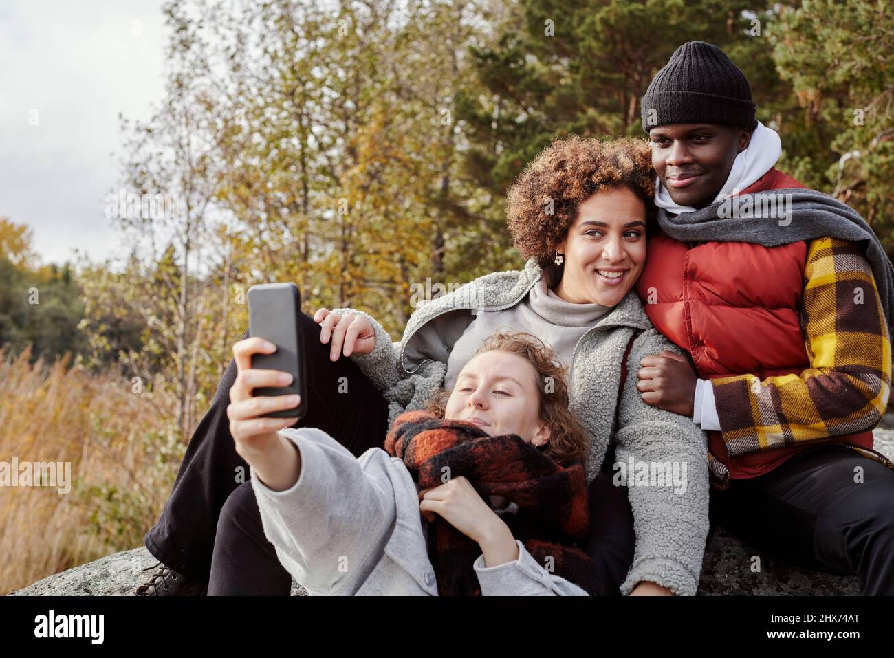 Group of friends taking selfie in nature Stock Photo