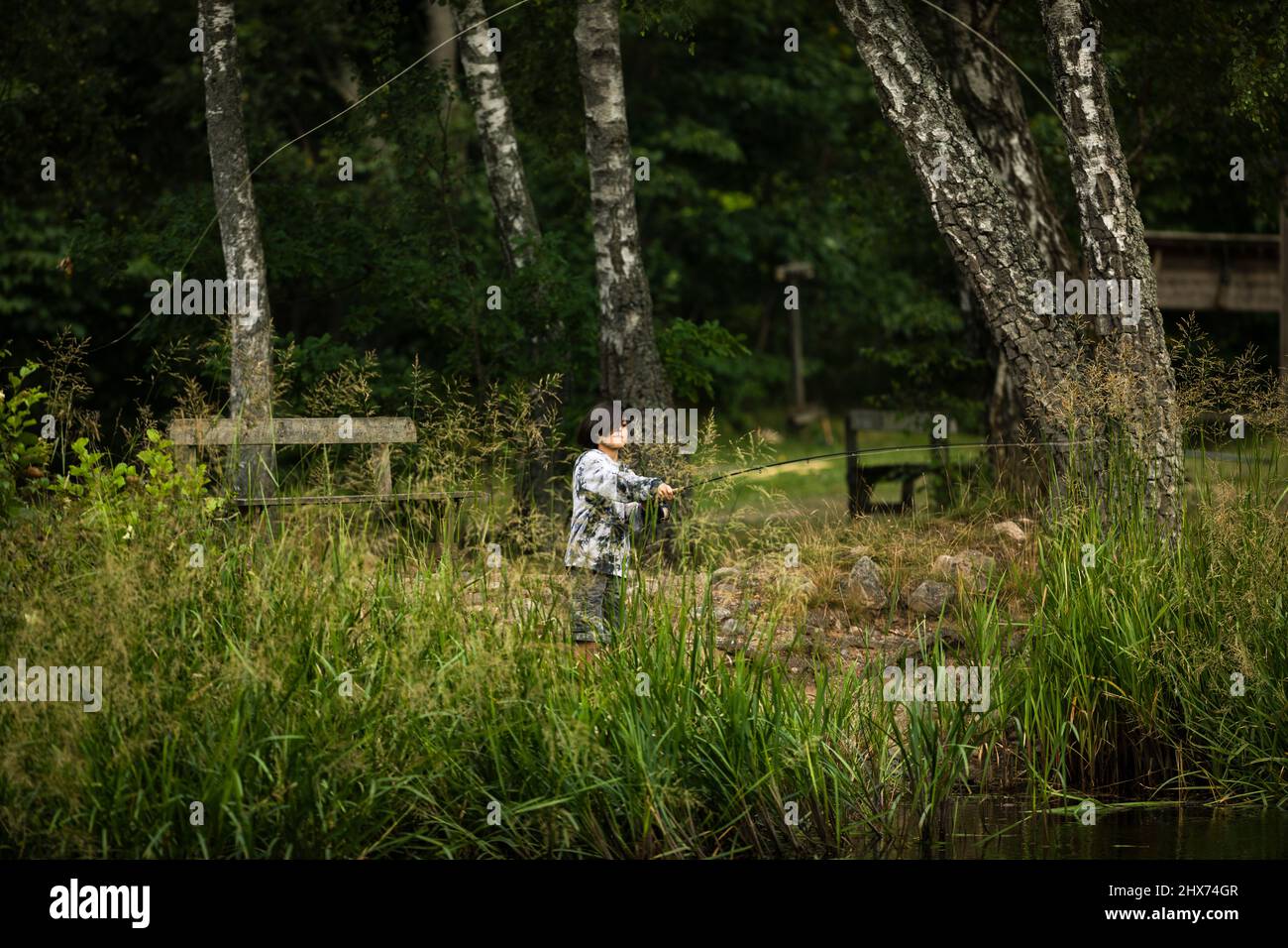 Side view boy fishing hi-res stock photography and images - Alamy