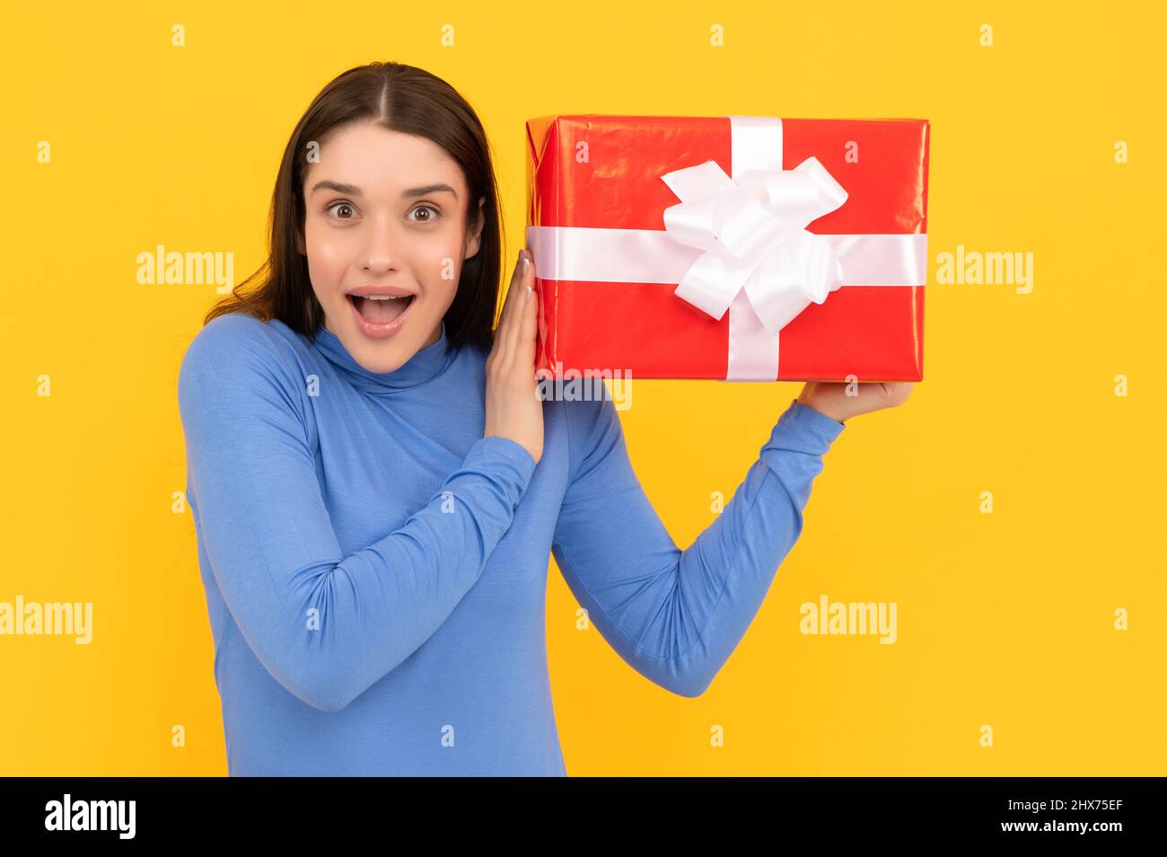 black friday discount. seasonal sales. curious girl with box on yellow background. boxing day. Stock Photo