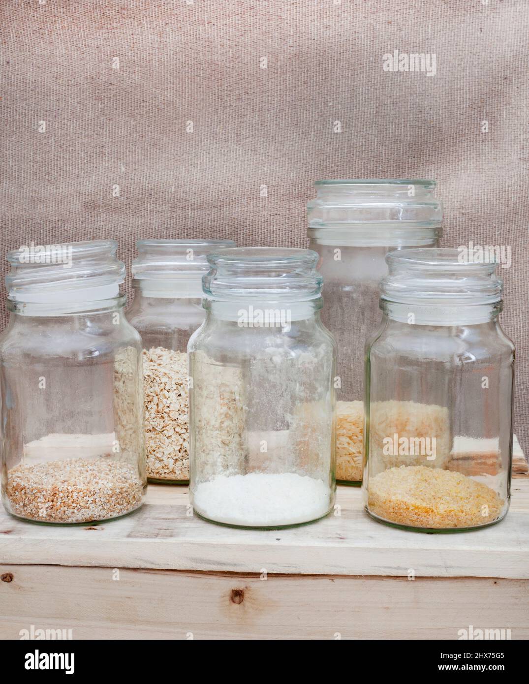 Glass jars with basic pantry stock almost finished Stock Photo Alamy