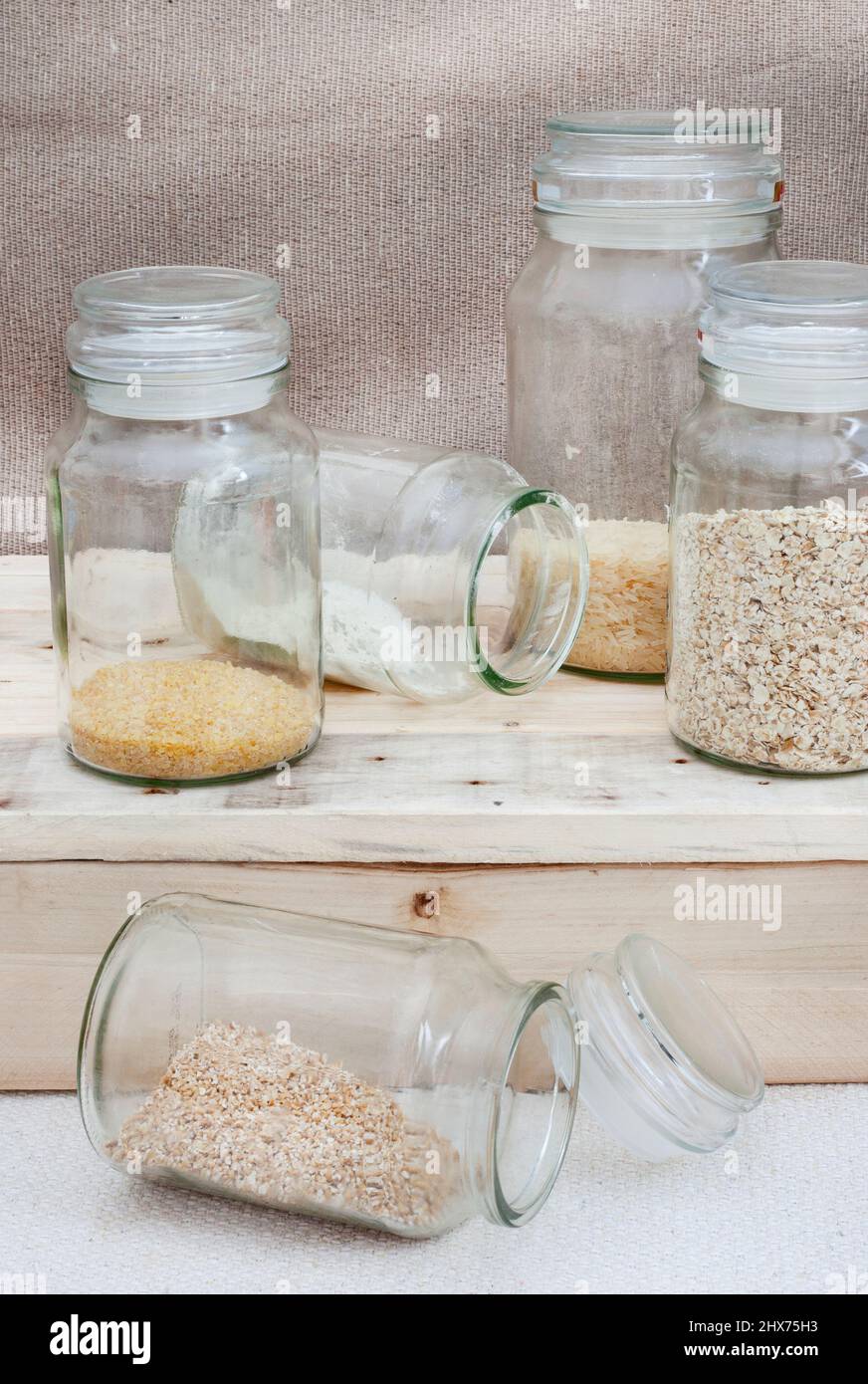 Glass jars with basic pantry stock almost finished Stock Photo