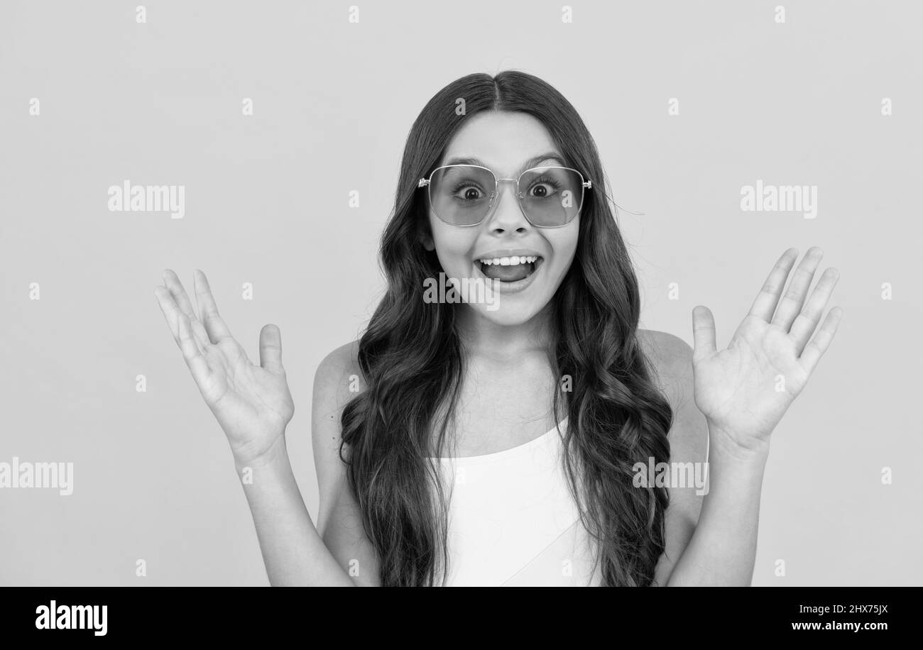 happy funny kid in eyeglasses. cool teen girl having fun in glasses
