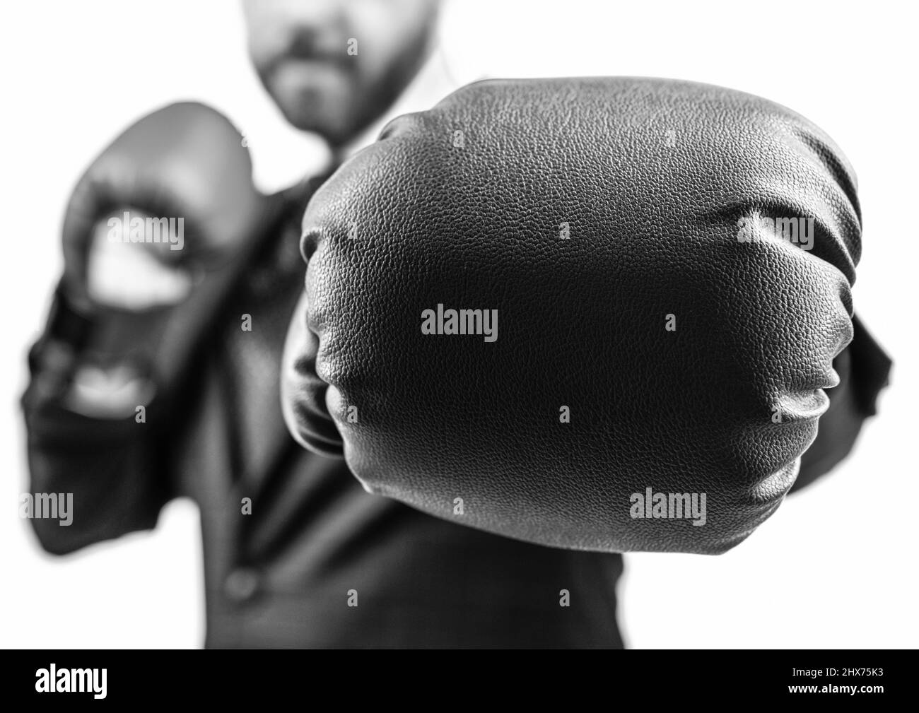 closeup punch of cropped businessman in boxing gloves ready for