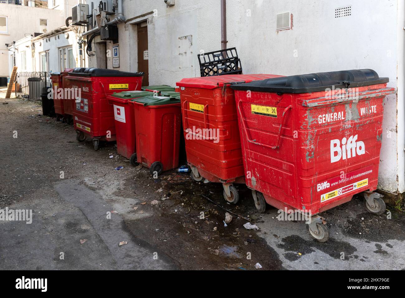 Biffa general waste disposal wheelie bins in a back street in Newquay in Cornwall. Stock Photo