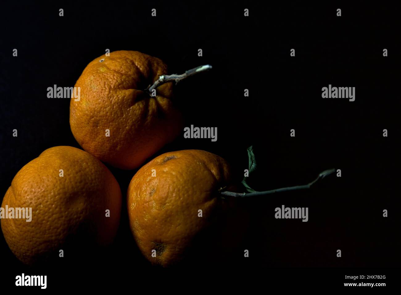 Three oranges on a black background Stock Photo