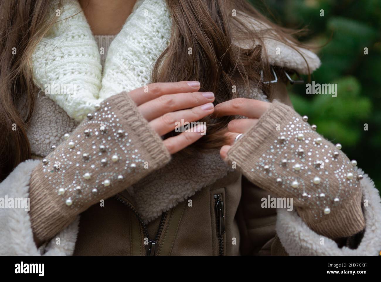 Female hands are playing with the hairs Stock Photo