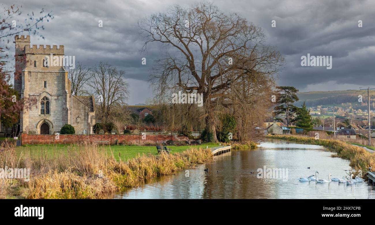 View of the restored Stroudwater Canal as it passes the Church of St Cyr near Stroud Gloucestershire, United Kingdom Stock Photo