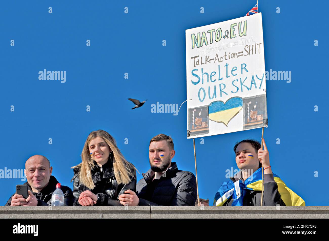 Activists hold a banner complaining about lack of action by NATO during the 2022 Russian invasion of Ukraine. They were part of a large solidarity rally in London against the Russian invasion of Ukraine 27 February 2022 Stock Photo