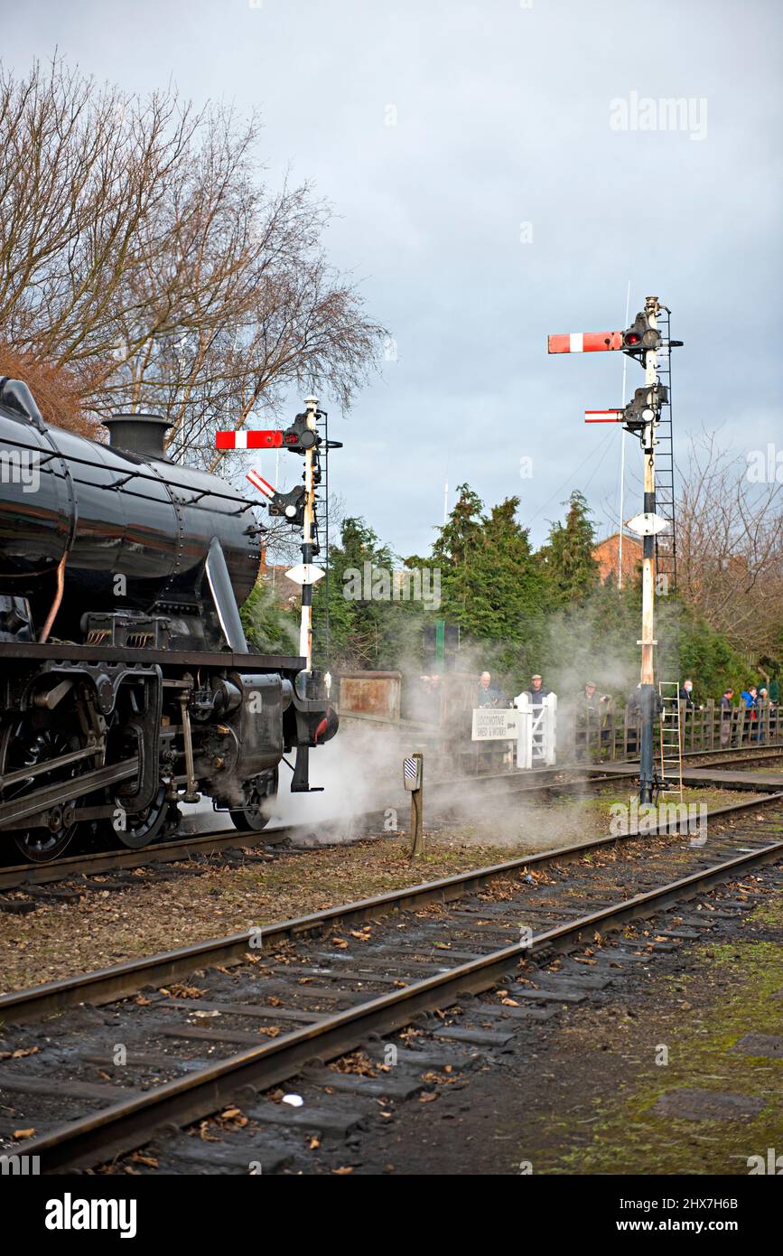 Preserved 8F No 48305 waits at the signals during the 2022 winter gala at the Great Central Railway heritage railway in Leicestershire Stock Photo