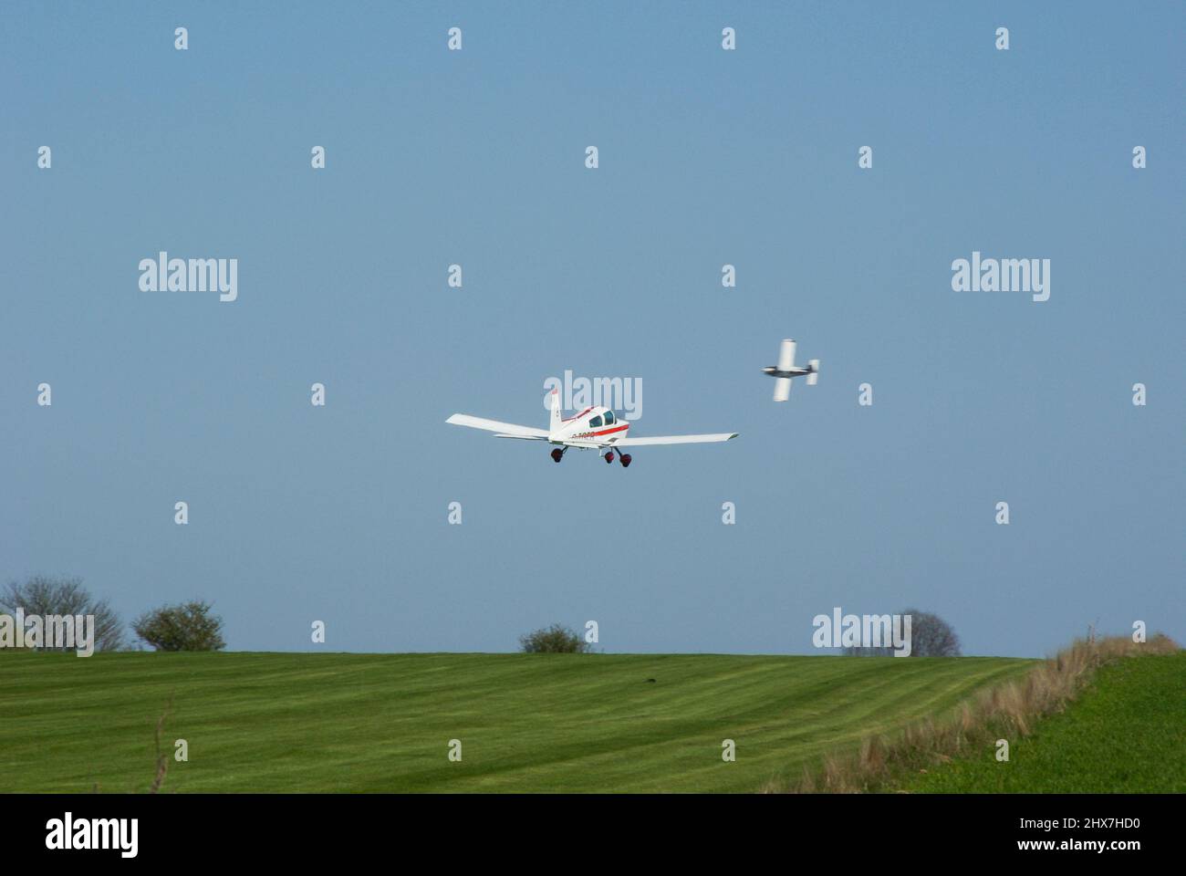 Planes taking off from Great Oakley grass airstrip in Essex to compete in the Royal Aero Club Air Race. Small private planes flying in air racing Stock Photo