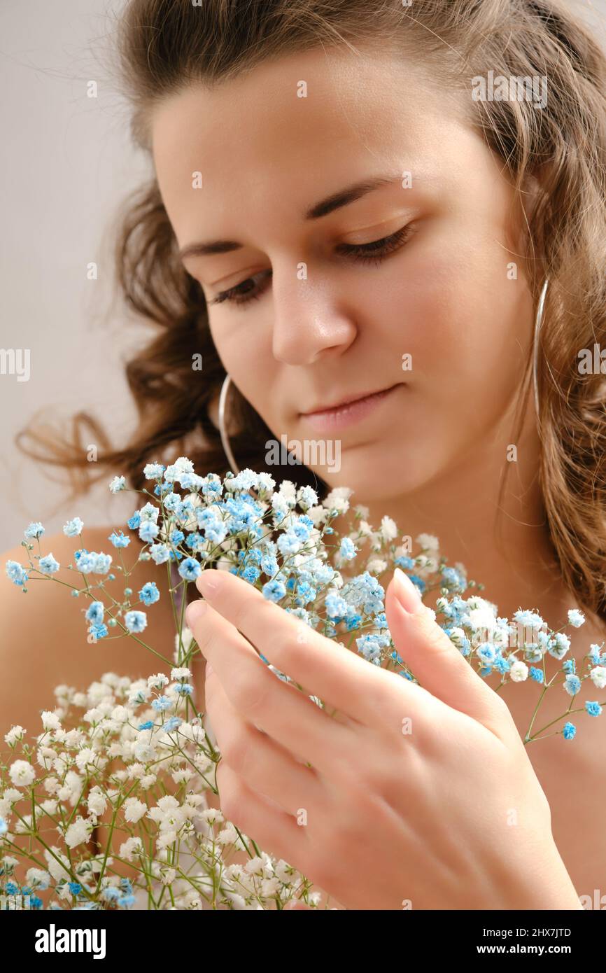 young happy woman in dress posing with flowers smiling Stock Photo - Alamy