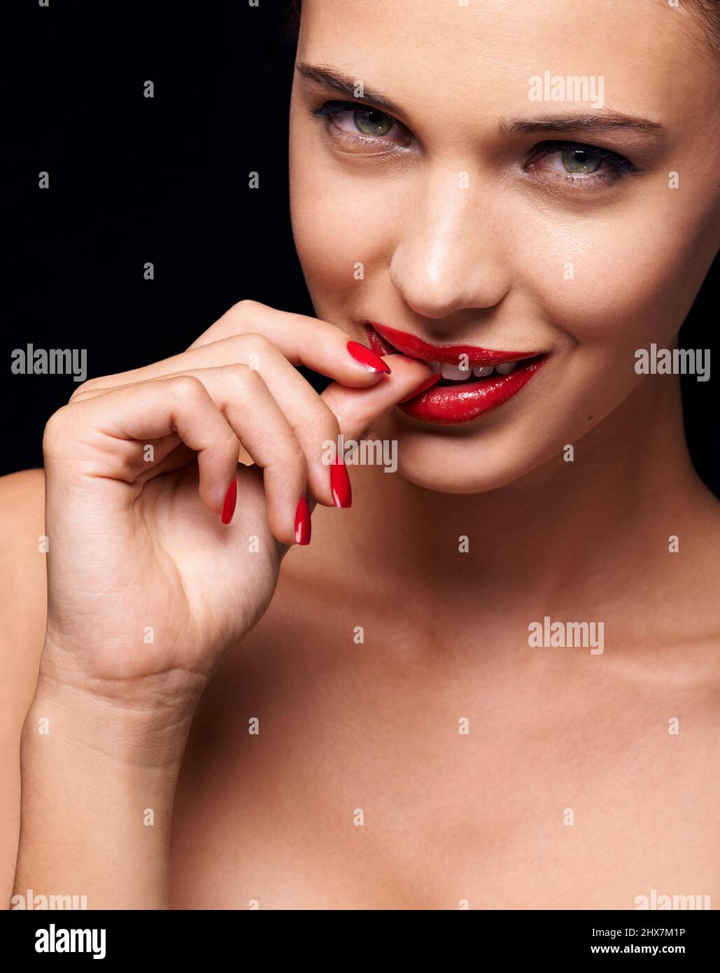 Ravenous red. A young woman with red lips and nails. Stock Photo