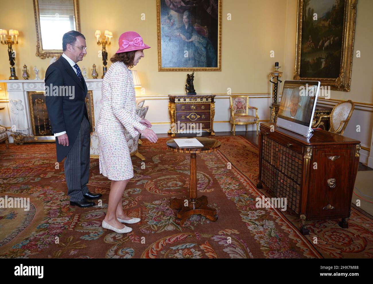 Queen Elizabeth II appears on a screen via videolink from Windsor Castle, where she is in residence, during a virtual audience to receive Marie Chatardová, Ambassador from the Czech Republic, and her husband Benoit Chatard, at Buckingham Palace, London. Picture date: Thursday March 10, 2022. Stock Photo
