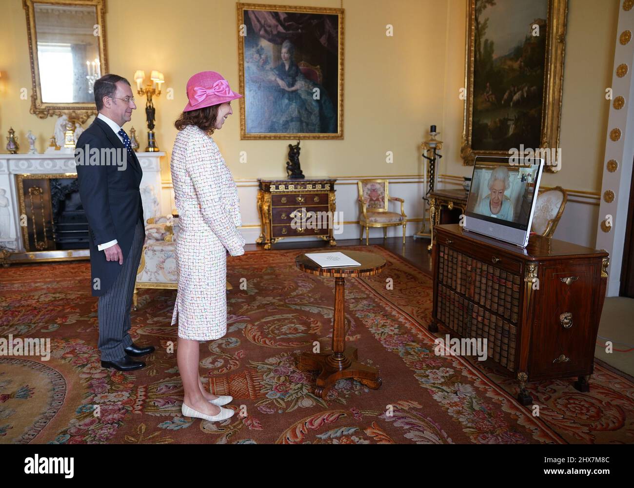 Queen Elizabeth II appears on a screen via videolink from Windsor Castle, where she is in residence, during a virtual audience to receive Marie Chatardová, Ambassador from the Czech Republic, and her husband Benoit Chatard, at Buckingham Palace, London. Picture date: Thursday March 10, 2022. Stock Photo
