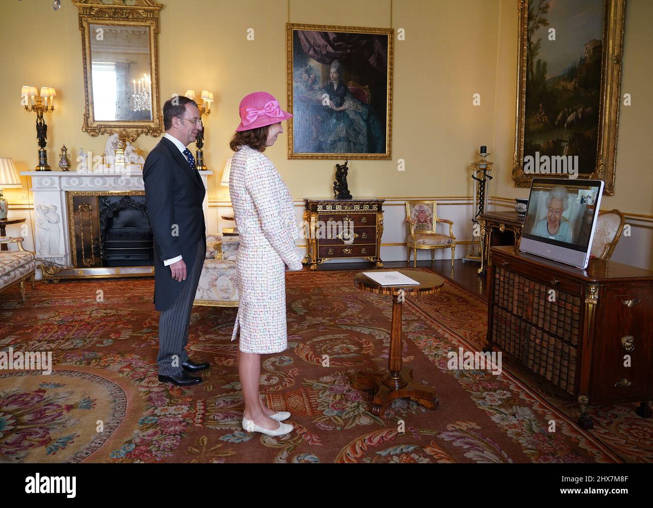 Queen Elizabeth II appears on a screen via videolink from Windsor Castle, where she is in residence, during a virtual audience to receive Marie ChatardovÃ¡, Ambassador from the Czech Republic, and her husband Benoit Chatard, at Buckingham Palace, London. Picture date: Thursday March 10, 2022. Stock Photo