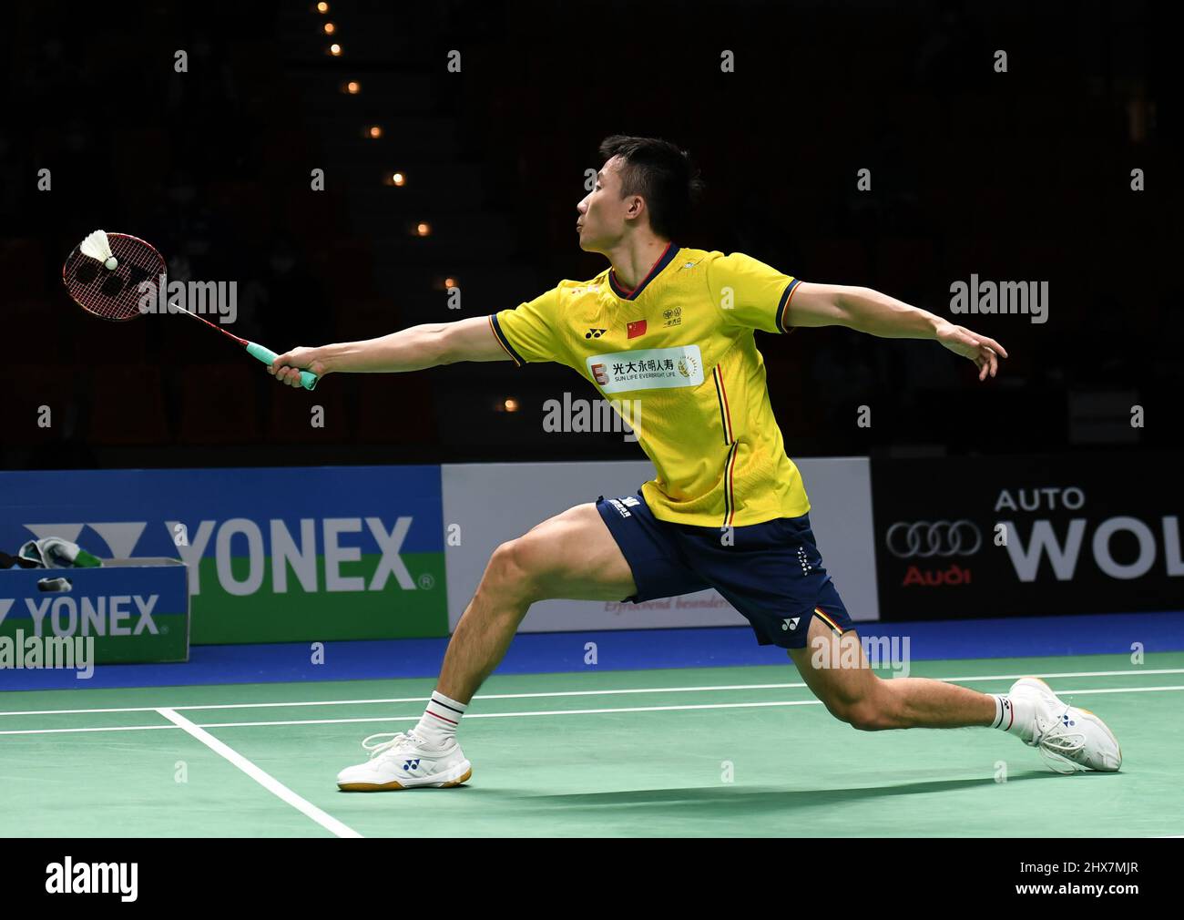 Lu Guangzu of China returns a shot to Loh Kean Yew of Singapore during the quarterfinal round of the mens single match in the Indonesia Masters badminton tournament at the Istora Stadium