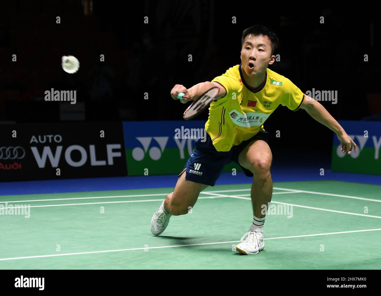 Lu Guangzu of China returns a shot to Loh Kean Yew of Singapore during the quarterfinal round of the mens single match in the Indonesia Masters badminton tournament at the Istora Stadium
