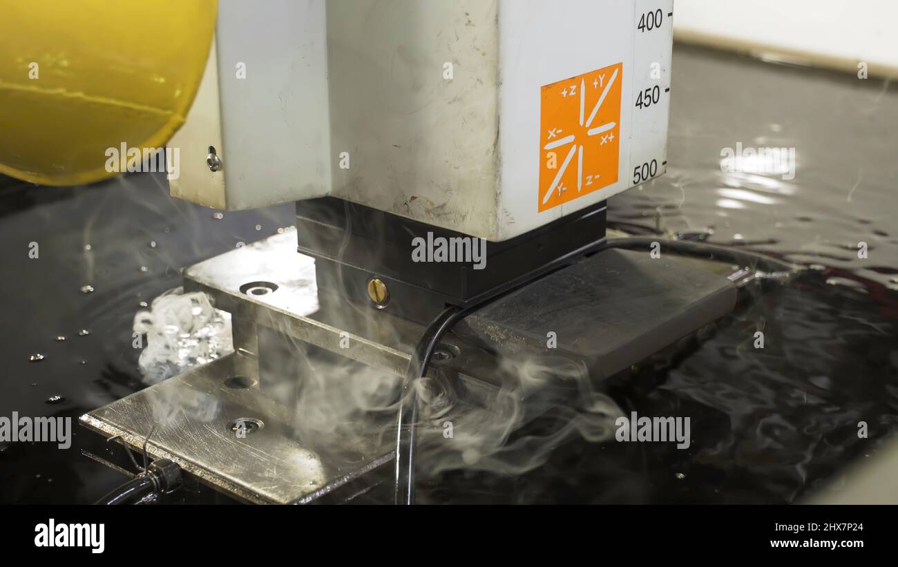 The abrasive water jet machine cutting the aluminium plate. Scene. The