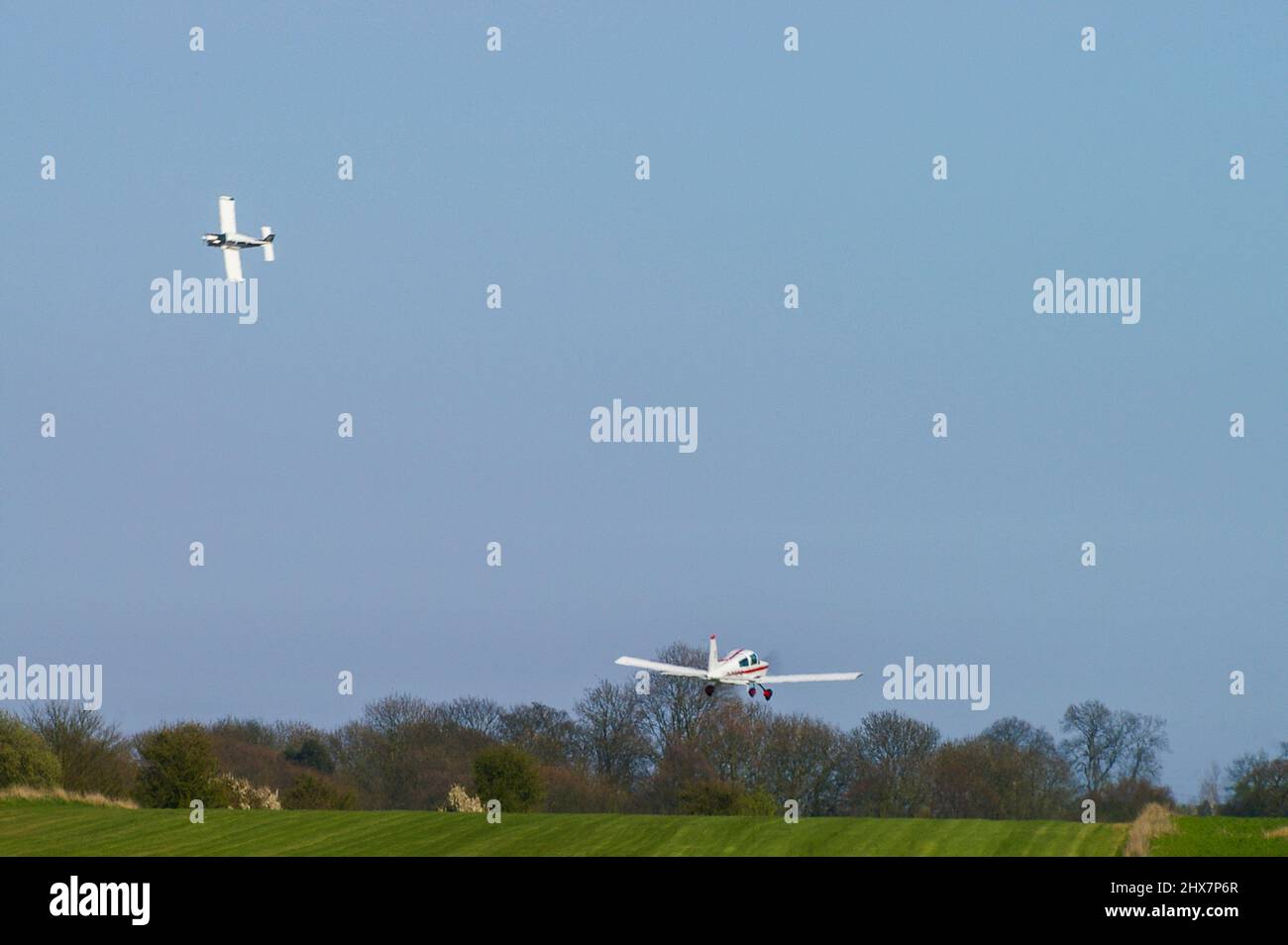 Planes taking off from Great Oakley grass airstrip in Essex to compete in the Royal Aero Club Air Race. Small private planes flying in air racing Stock Photo