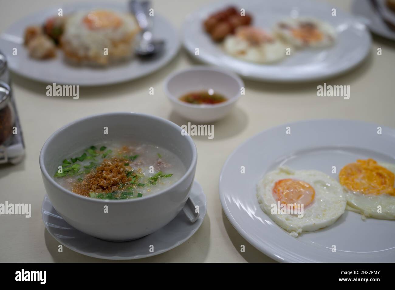 rice soup with fried eggs on the table Stock Photo